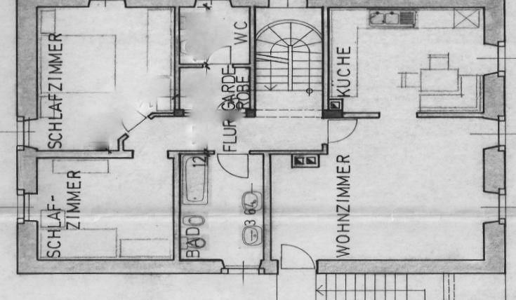 Ein Grundriss einer Wohnung mit mehreren Räumen. Die Bereiche umfassen ein Wohnzimmer, Schlafzimmer, Küche und Badezimmer.