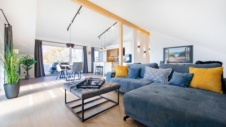 A modern, spacious living-dining area, the large windows let in plenty of daylight and offer a wonderful view of nature.