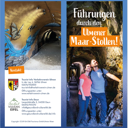 Das Bild zeigt eine Führung durch den Ulmener Maar-Stollen, mit Stalaktiten und beeindruckenden Felsformationen. Ein Paar steht lächelnd in einem beleuchteten Tunnel.