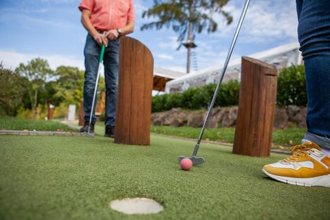 two people playing mini golf